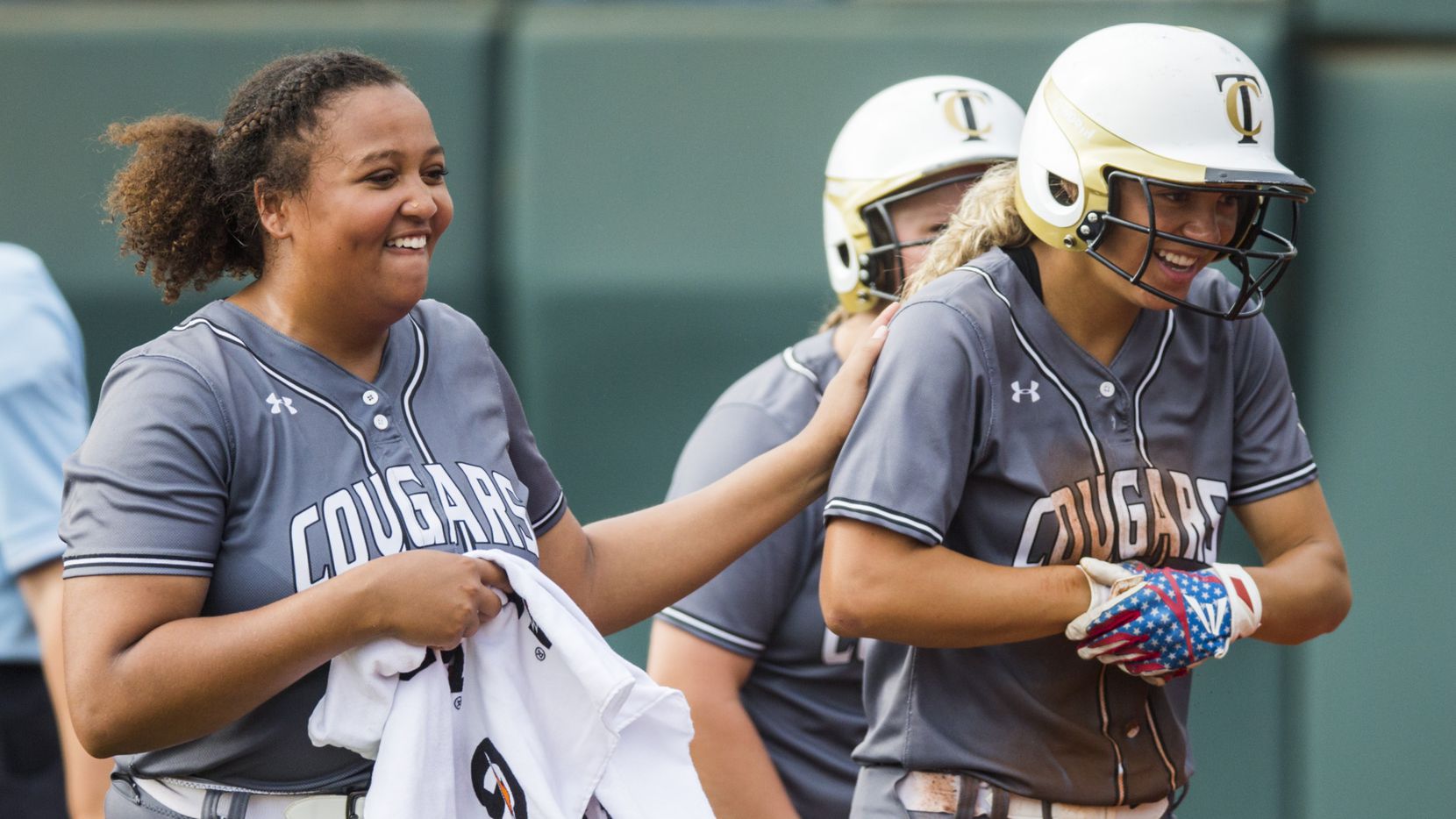 The Colony's Jayda Coleman (10, right) celebrates a run with pitcher Karlie Charles (29)...