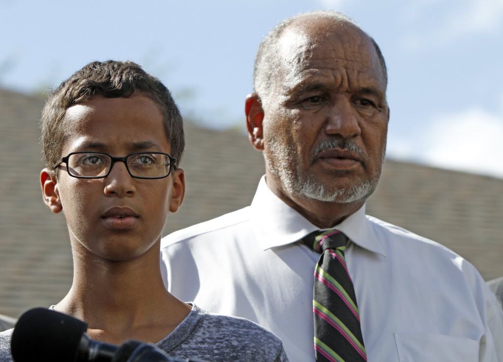 Ahmed Mohamed stands with his father Mohamed Elhassan Mohamed during a news conference on...