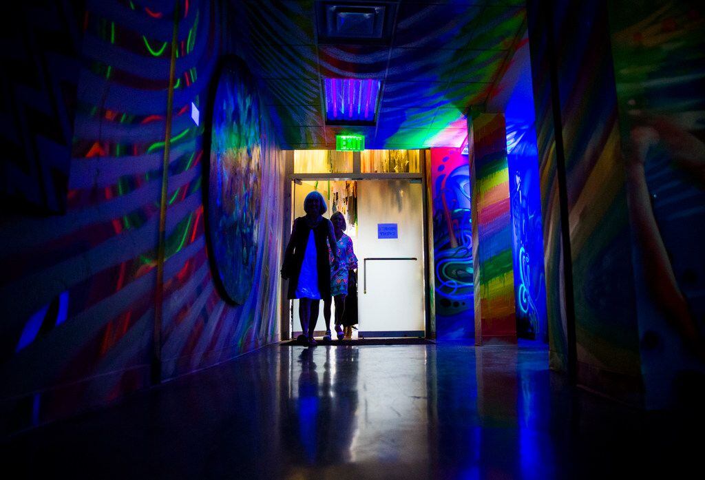 People walk in to The Vortex by Michael McPheeters and IZK inside a new pop-up art...