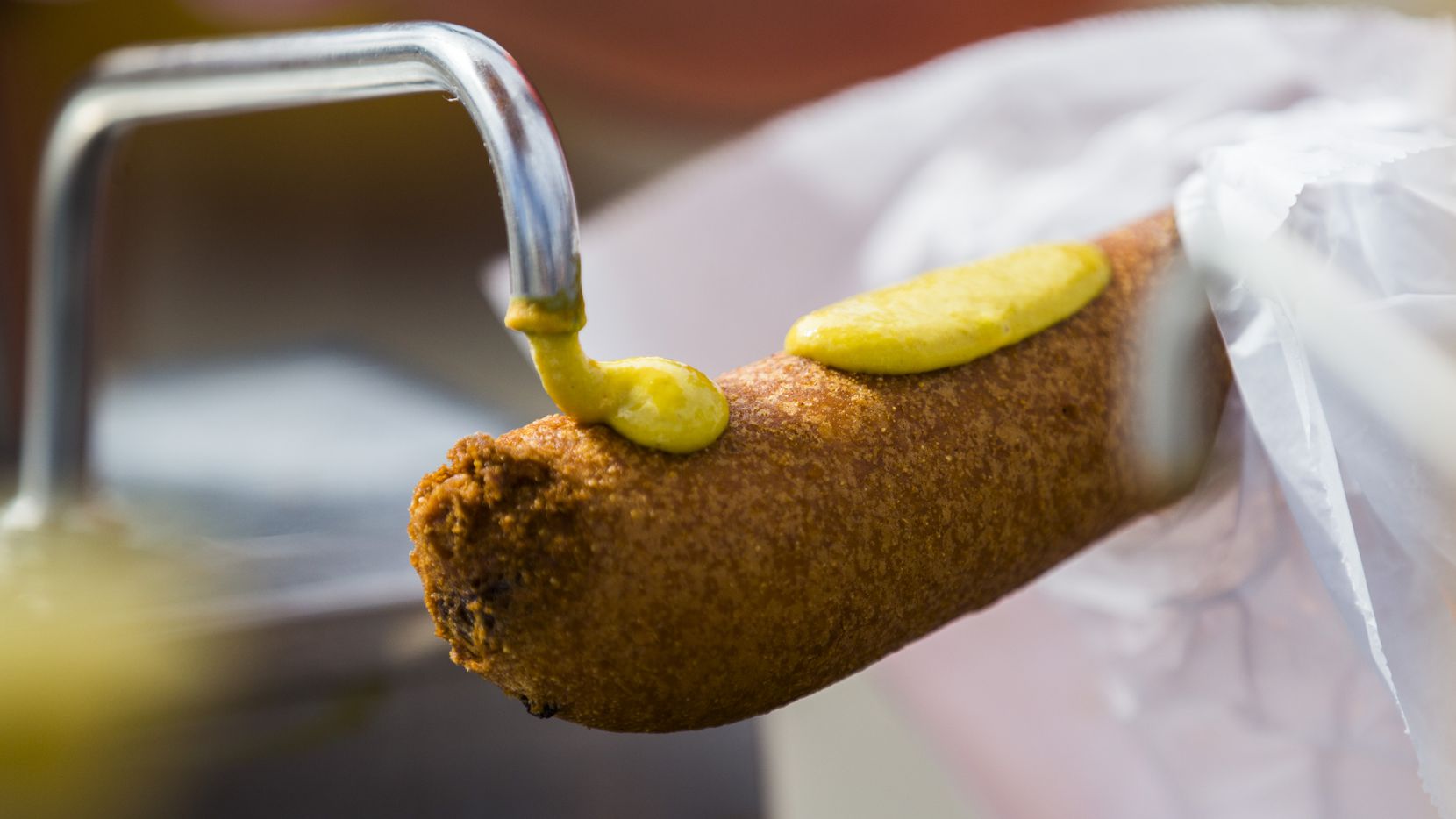The "right" way to eat a Fletcher's corny dog at the State Fair of Texas is with mustard,...