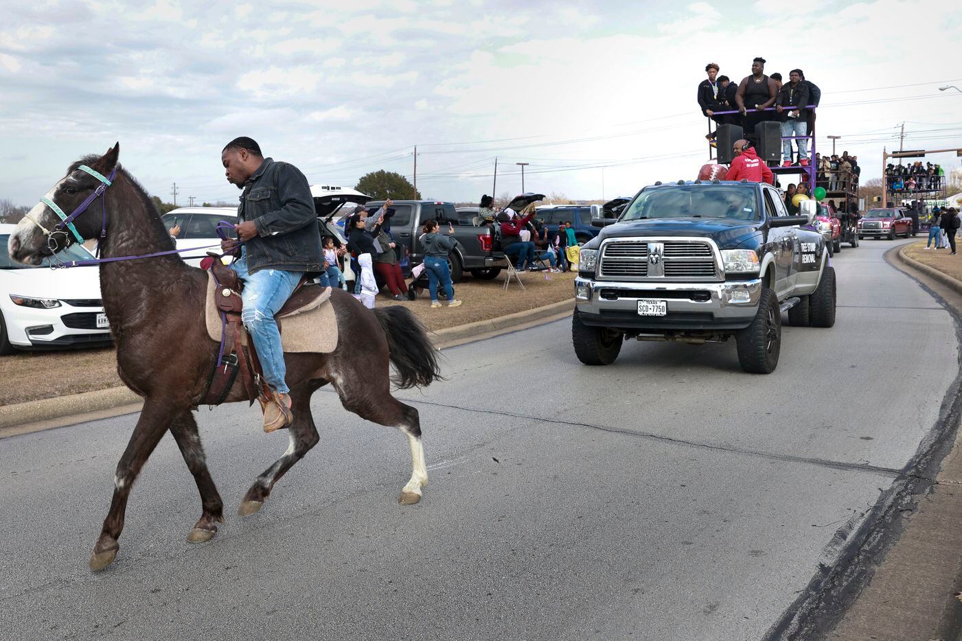DeSoto High School football players ride on top of a double-decker trailer, Saturday, Jan....