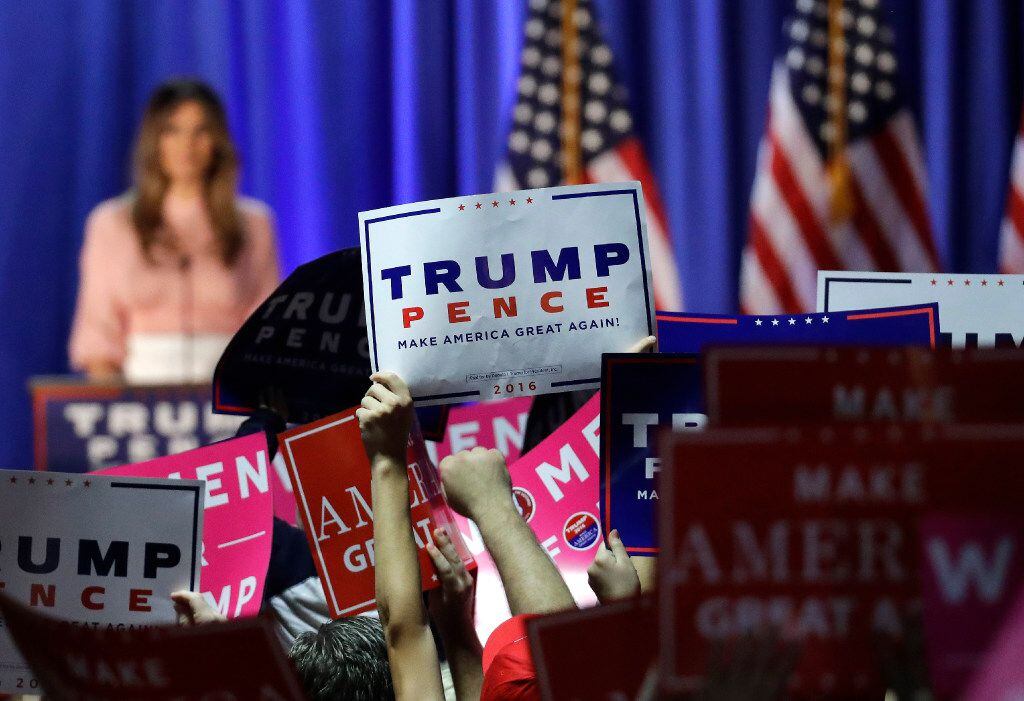 Supporters of Republican presidential candidate Donald Trump hold up signs as Trump's wife,...