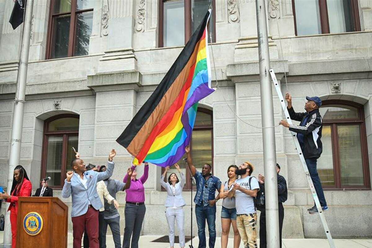 Philadelphia's new rainbow Pride flag, which includes black and brown stripes, is raised at...