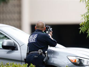 A Dallas police officer on alert at Dallas Police Headquarters where a credible threat was...