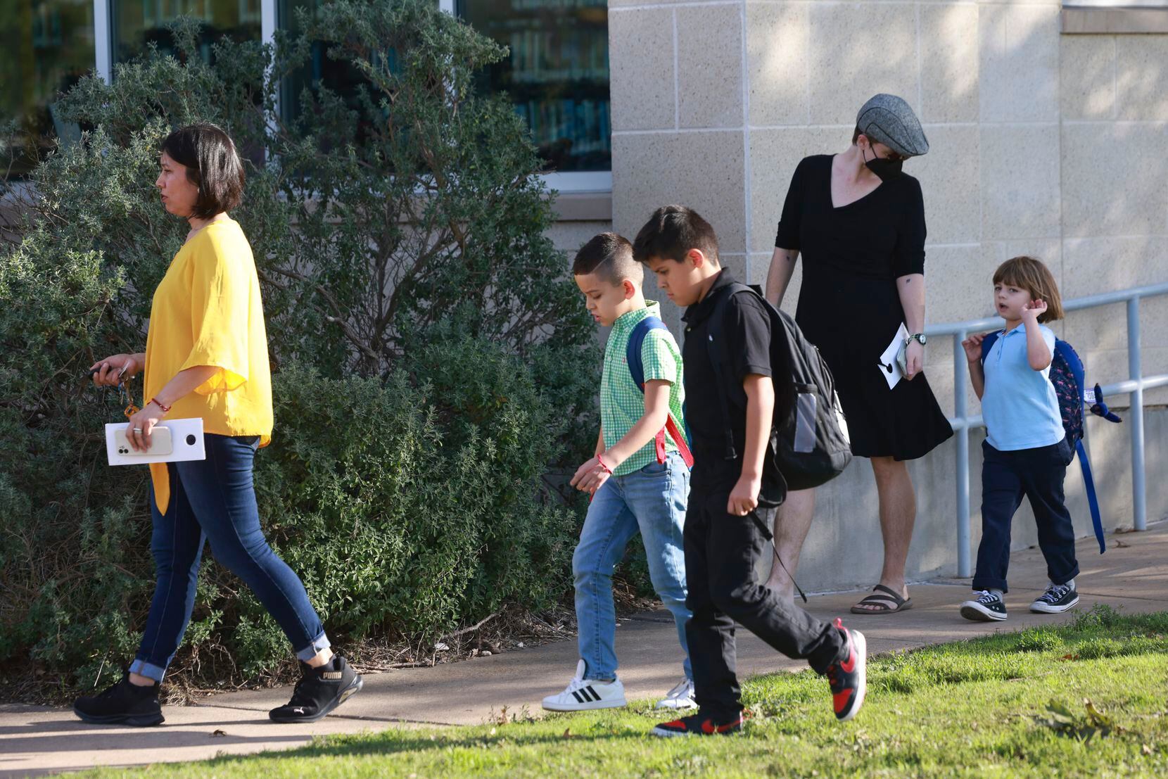 Students walked to their parents' cars during school dismissal at Brashear Elementary...