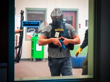 A school marshal participates in a school safety active shooter training demonstration...