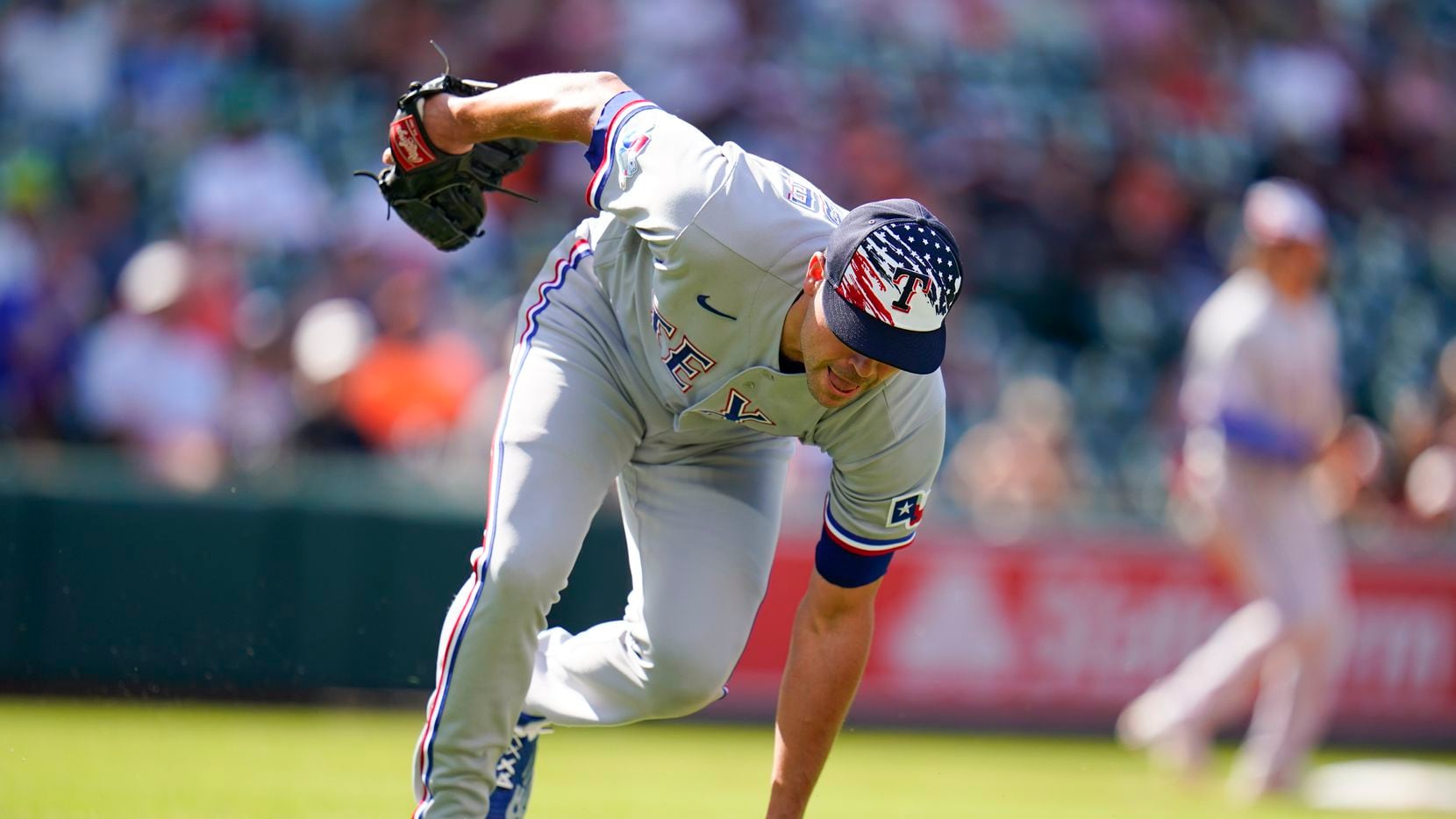 Texas Rangers relief pitcher Matt Moore is unable to handle a bunt single by Baltimore...