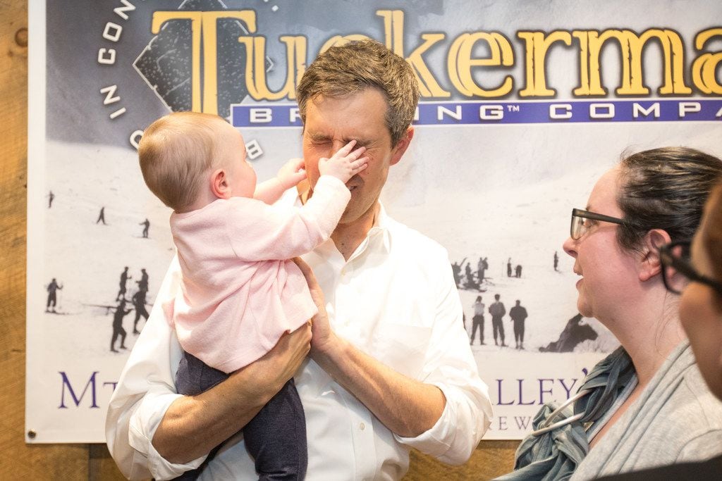 Democratic presidential candidate Beto O'Rourke has his face grabbed by a baby at a meet and...