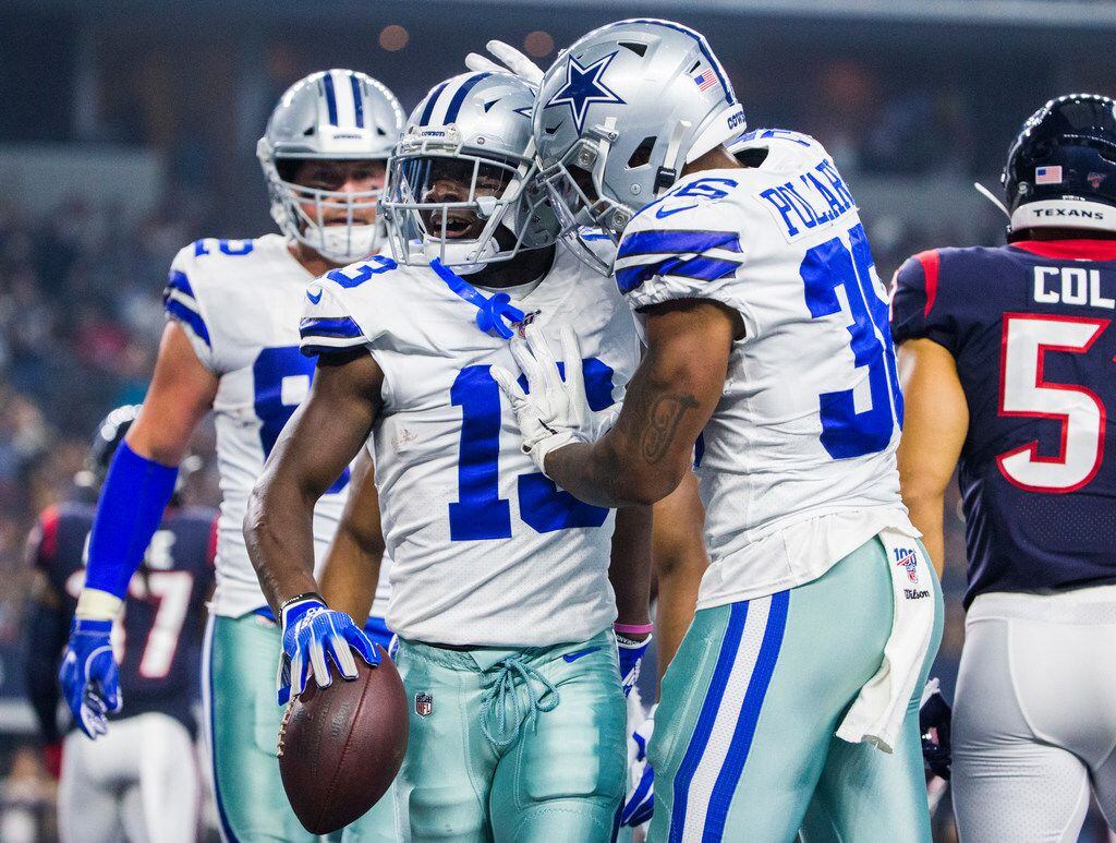 Dallas Cowboys wide receiver Michael Gallup (13) celebrates with running back Tony Pollard...