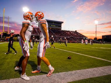 Rockwall wide receiver Caden Marshall (11) celebrates with Noble Johnson (3) after scoring...
