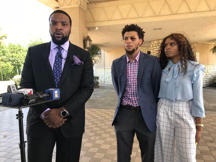 From left: Attorney Lee Merritt, Jalen Bell and Logan Bell hold a news conference Wednesday...