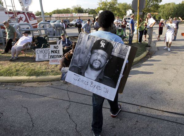 In this 2019 file photo, Ricky Jason wears a photograph of James Byrd Jr. outside the Texas...