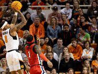 Oklahoma State's Avery Anderson III (0) shoots over Mississippi's Amaree Abram (1) in the...