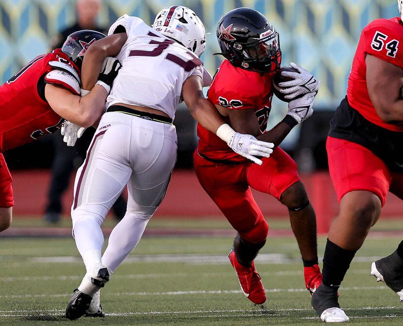 Coppell running back Xavier Mosely (28) finds a small hole to run past Lewisville defensive...