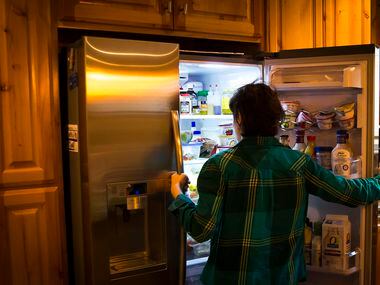 Kara Zartler looks into the family's refrigerator after she got home from school on...