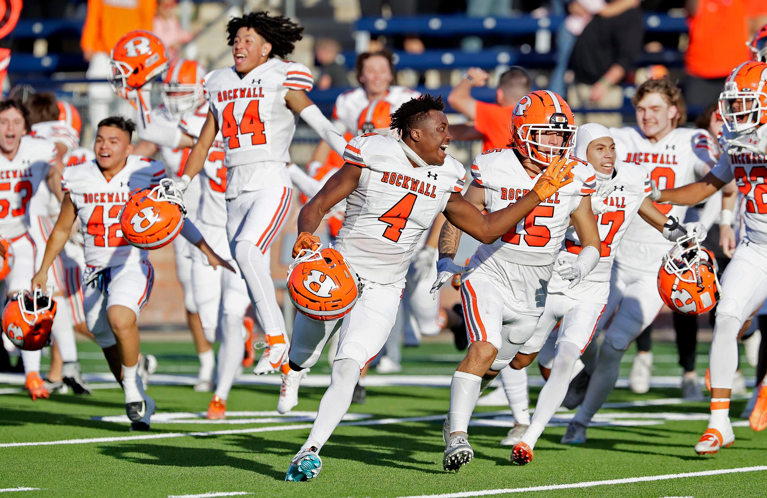 The Rockwall High School football team storms the field after holding on to win 46-43 as...