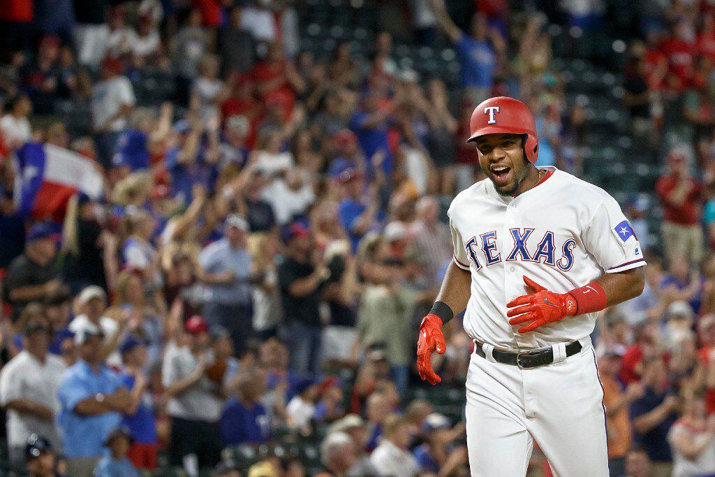Texas Rangers shortstop Elvis Andrus celebrates as he rounds the bases after hitting a 3-run...