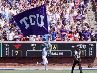 TCU mascot SuperFrog runs with a flag after a touchdown during the first half of a game...