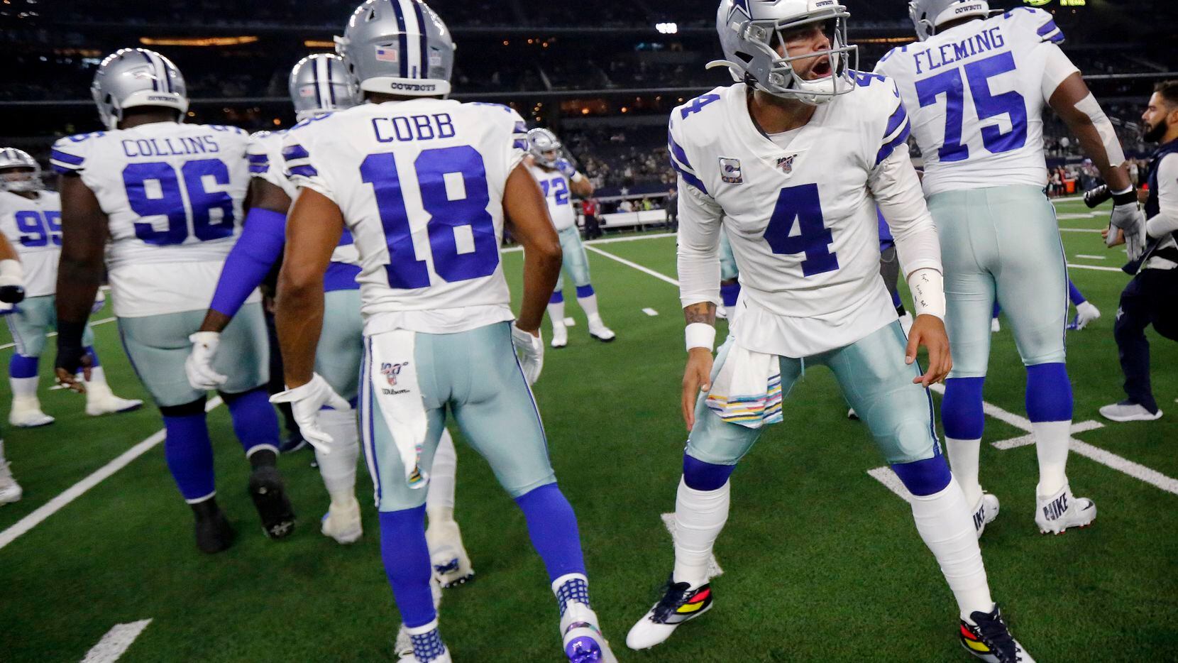 Dallas Cowboys quarterback Dak Prescott (4) greets his teammates as the defense arrives on...