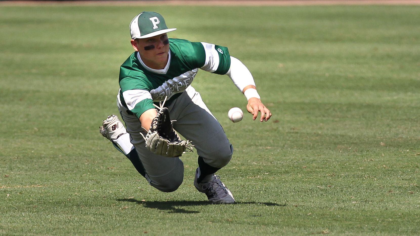 FILE - Prosper's Steele Walker makes a diving grab in center field against Tomball during...
