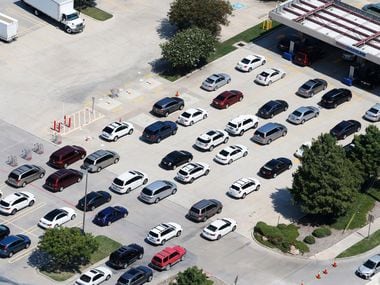 People wait in line to get gas at the Costco at Sam Rayburn Tollway and I-35 in Lewisville...