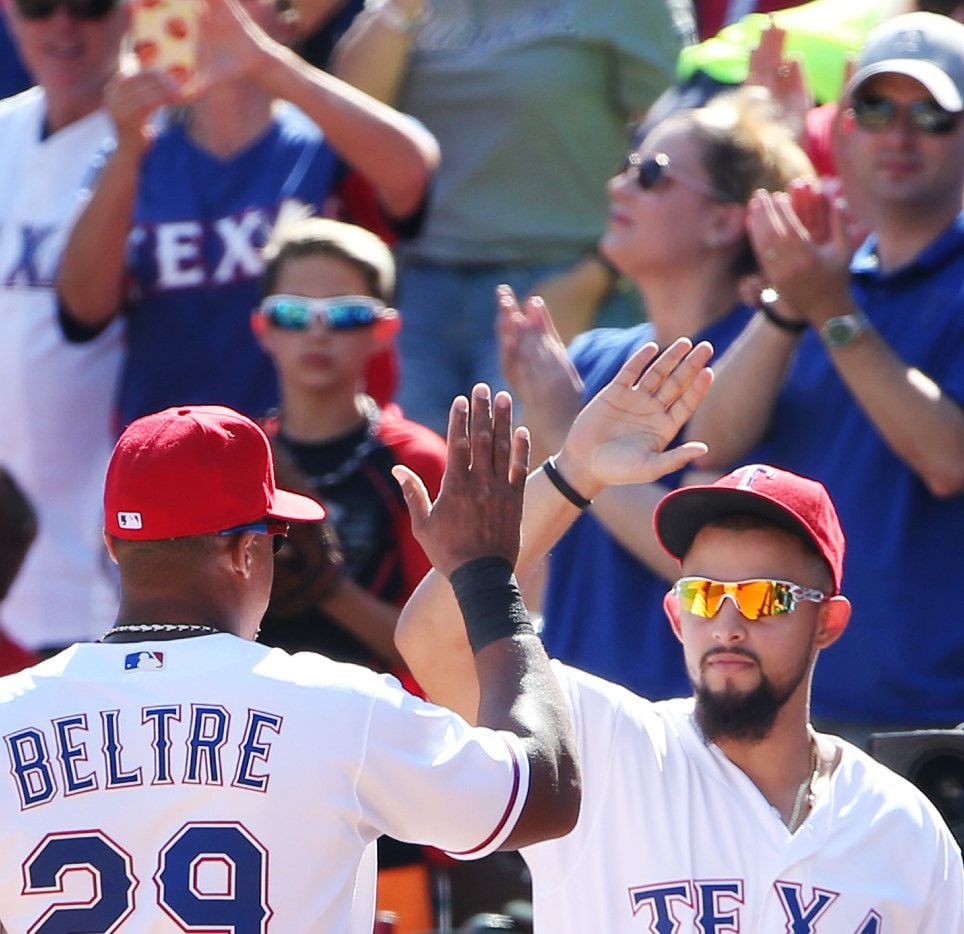 Texas Rangers second baseman Rougned Odor (12) greets third baseman Adrian Beltre (29) after...