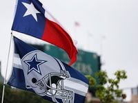 Dallas Cowboys and Texas flags blow in the wind. (Vernon Bryant/The Dallas Morning News)