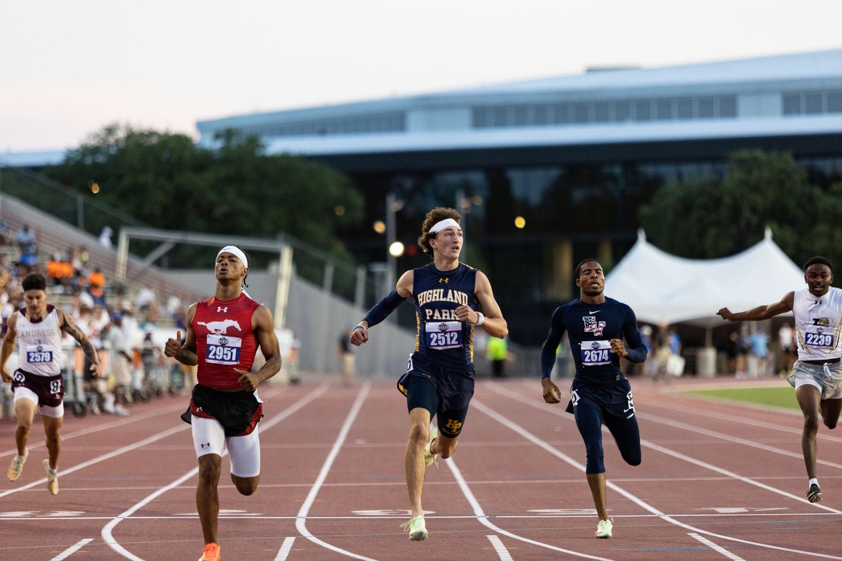 John Rutledge of Dallas Highland Park looks to the scoreboard for official times after the...