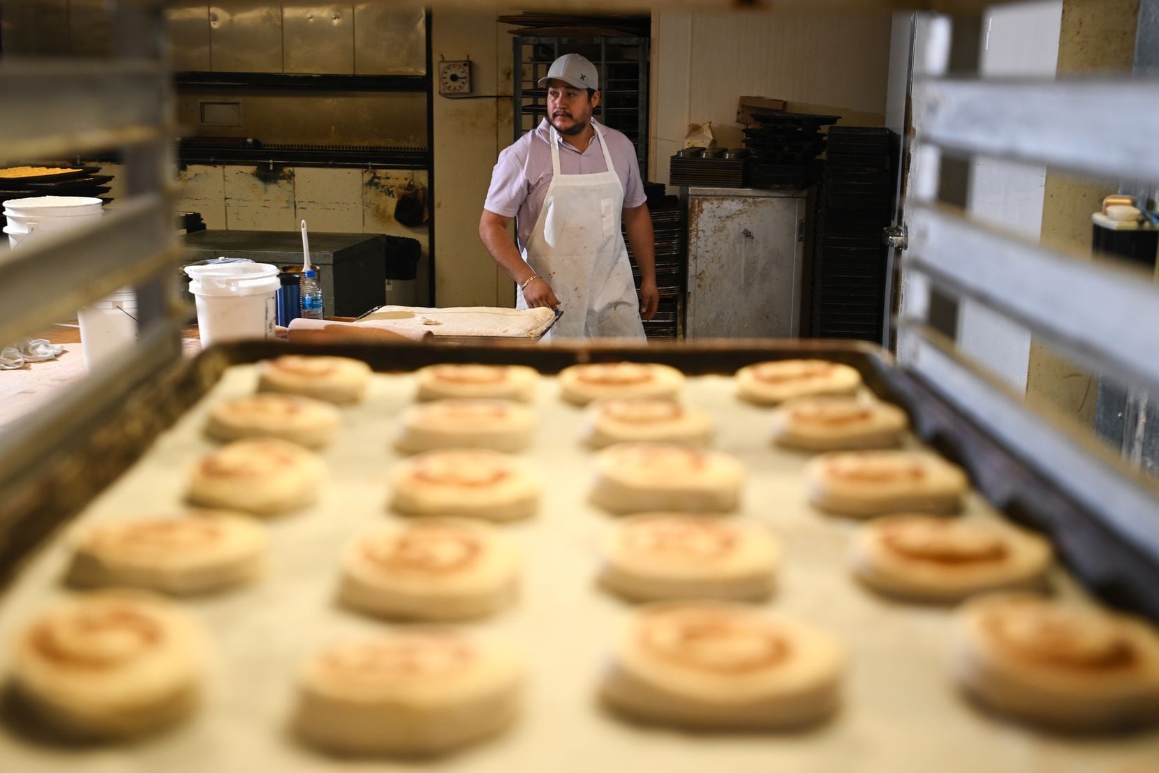 A tray of danishes are shown as baker Inocencio Sariñana prepares to finish the batch at...
