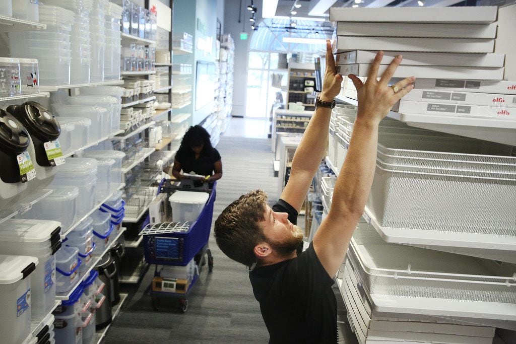 Jeremy Pope-Levison, a visual sales associate, places merchandise during a tour of the newly...