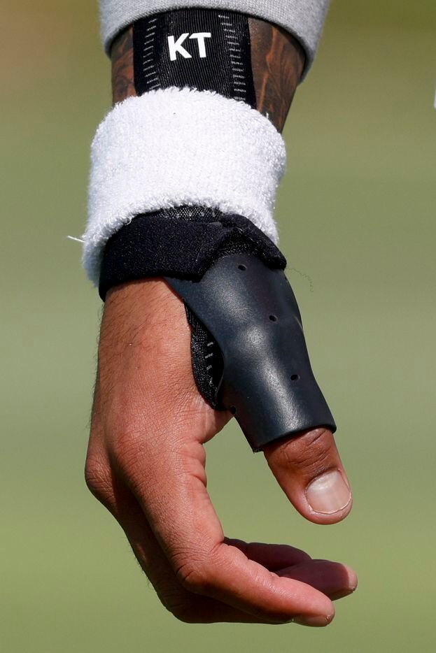 Dallas Cowboys quarterback Dak Prescott (4) wears a brace on his injured thumb during a...