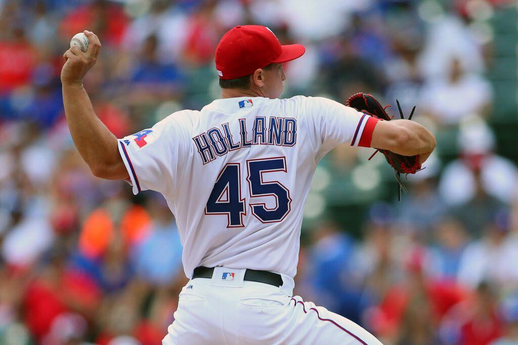 ARLINGTON, TX - AUGUST 28:  Derek Holland #45 of the Texas Rangers pitches in the second...