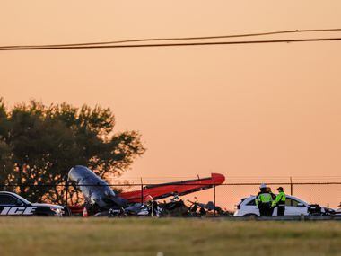 The sun begins to set over the damage from a mid-air collision between two planes that sits...