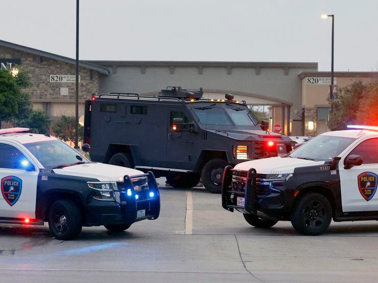 Law enforcement including Plano Police secure the scene after a mass shooting at the Allen...