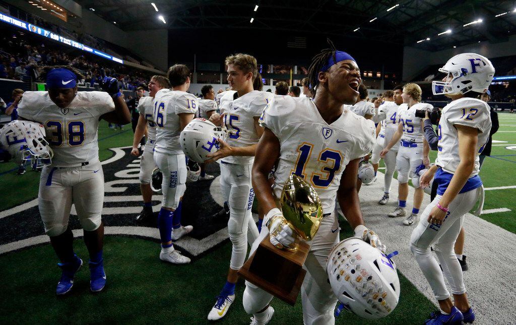 Frisco's Blake May (13) and teammates celebrate after their 18-0 win in a high school...