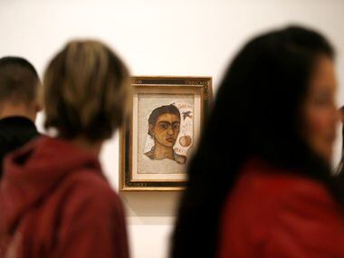 Crowds move past "Self-Portrait, Very Ugly" by Frida Kahlo in the "Mexico 1900-1950"...