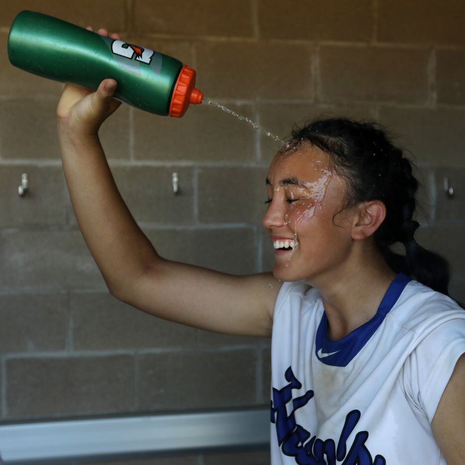 Hebron High School player #8, Shorey Nguyen, tries to cool off during a softball playoff...