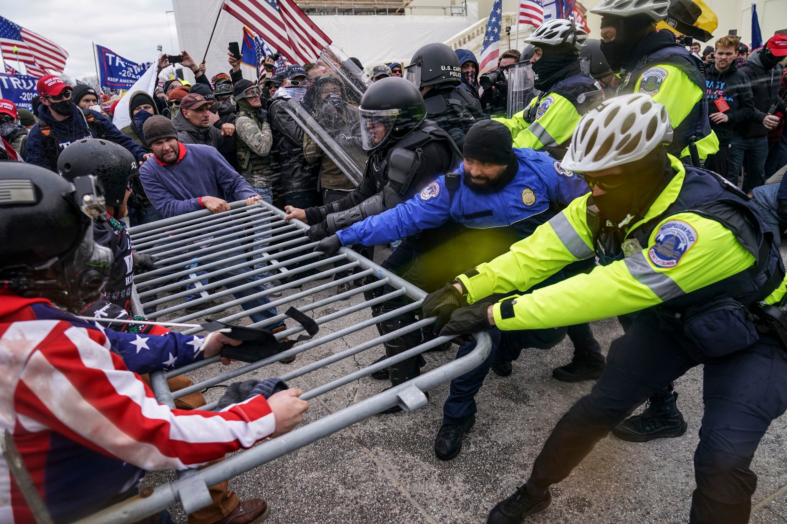 Trump supporters try to break through a police barrier, Wednesday, Jan. 6, 2021, at the...