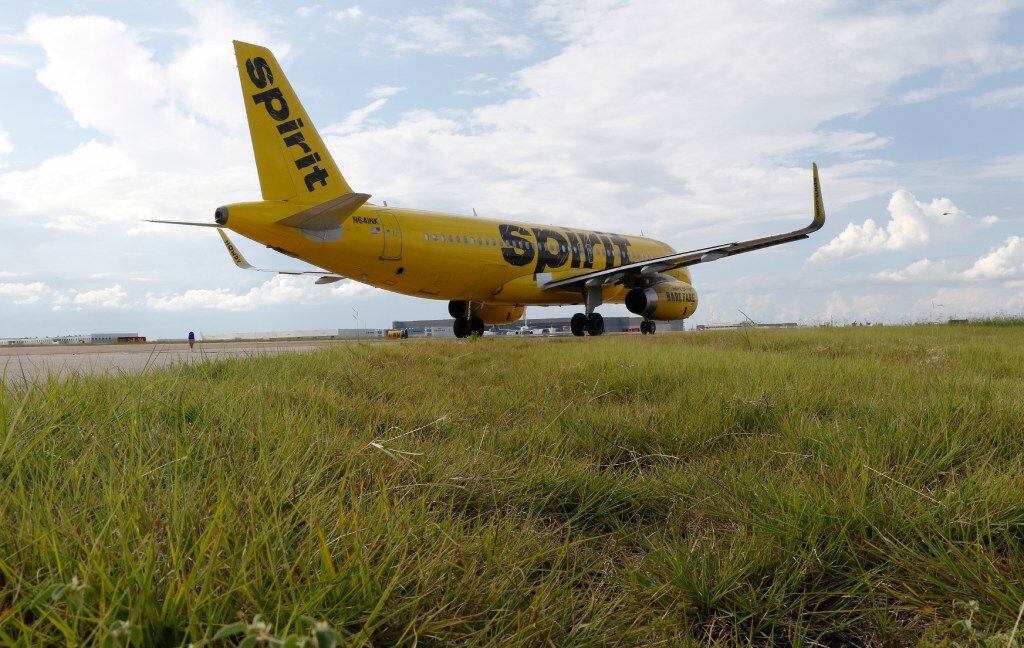 A Spirit Airlines plane taxis at DFW International Airport.