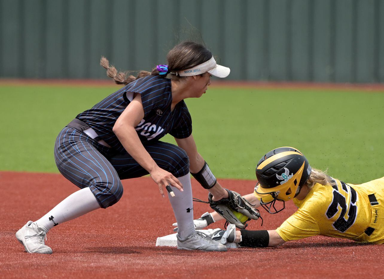 Forney’s Chloe Good (23) steals second base in front of the tag by Prosper Rock Hill's...