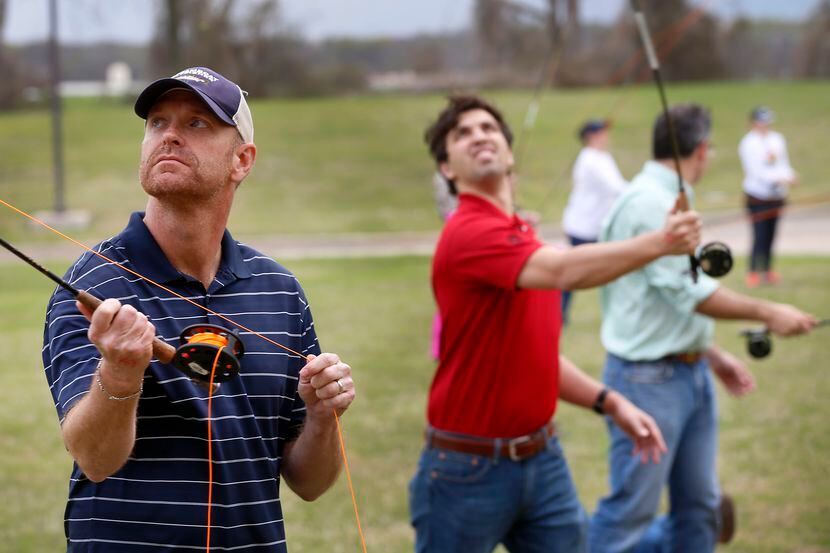 A group of people including James Graham (left) takes casting lessons during the Texas Fly...