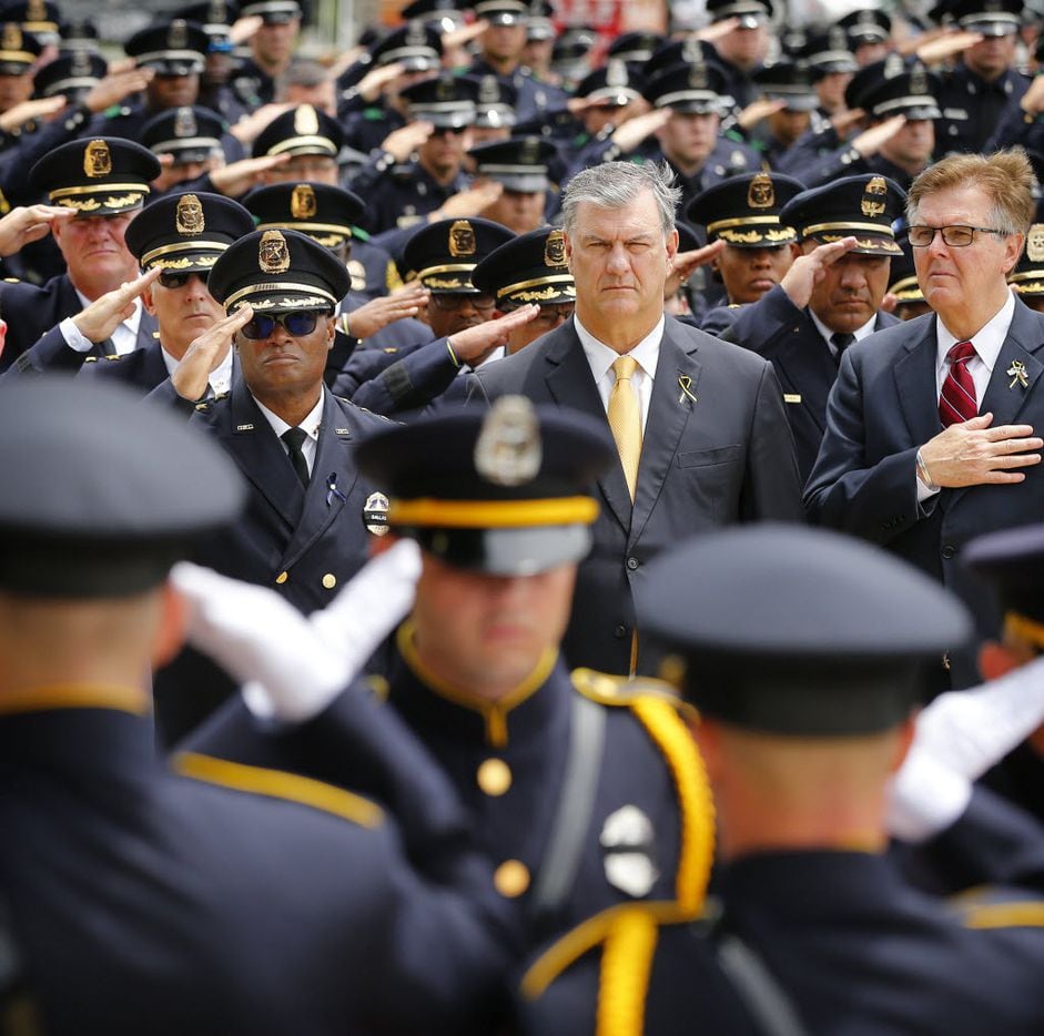 (from left) Dallas police Chief David Brown (facing with sunglasses), Dallas Mayor Mike Rawlings  and Texas Lt Gov. Dan Patrick watch as the Dallas Police Honor Guard salutes carries the flag-draped casket of Dallas police officer Michael Krol outside of Prestonwood Baptist Church in Plano, Texas, Friday, July 15, 2016.  (Tom Fox/The Dallas Morning News, pool photo)