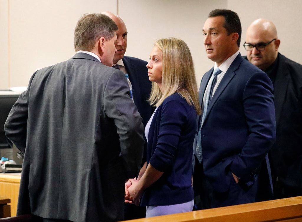 Amber Guyger visits with defense attorneys after taking the stand in her murder trial Friday.