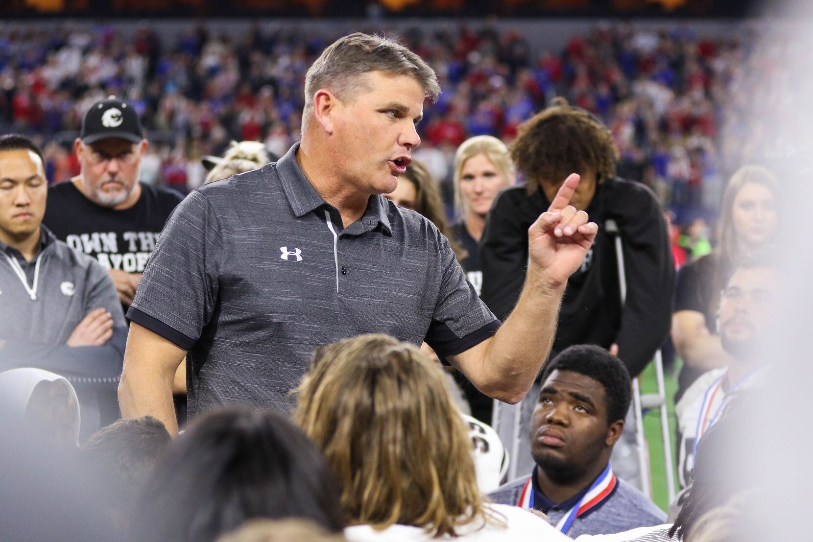 Denton Guyer's coach John Walsh talks to his team after losing a Class 6A Division II state...