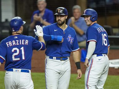 Texas Rangers first baseman Todd Frazier celebrates with Joey Gallo and Scott Heineman after driving them in with a 3-run home run during the fifth inning of an exhibition game against the Colorado Rockies at Globe Life Field on Wednesday, July 22, 2020.