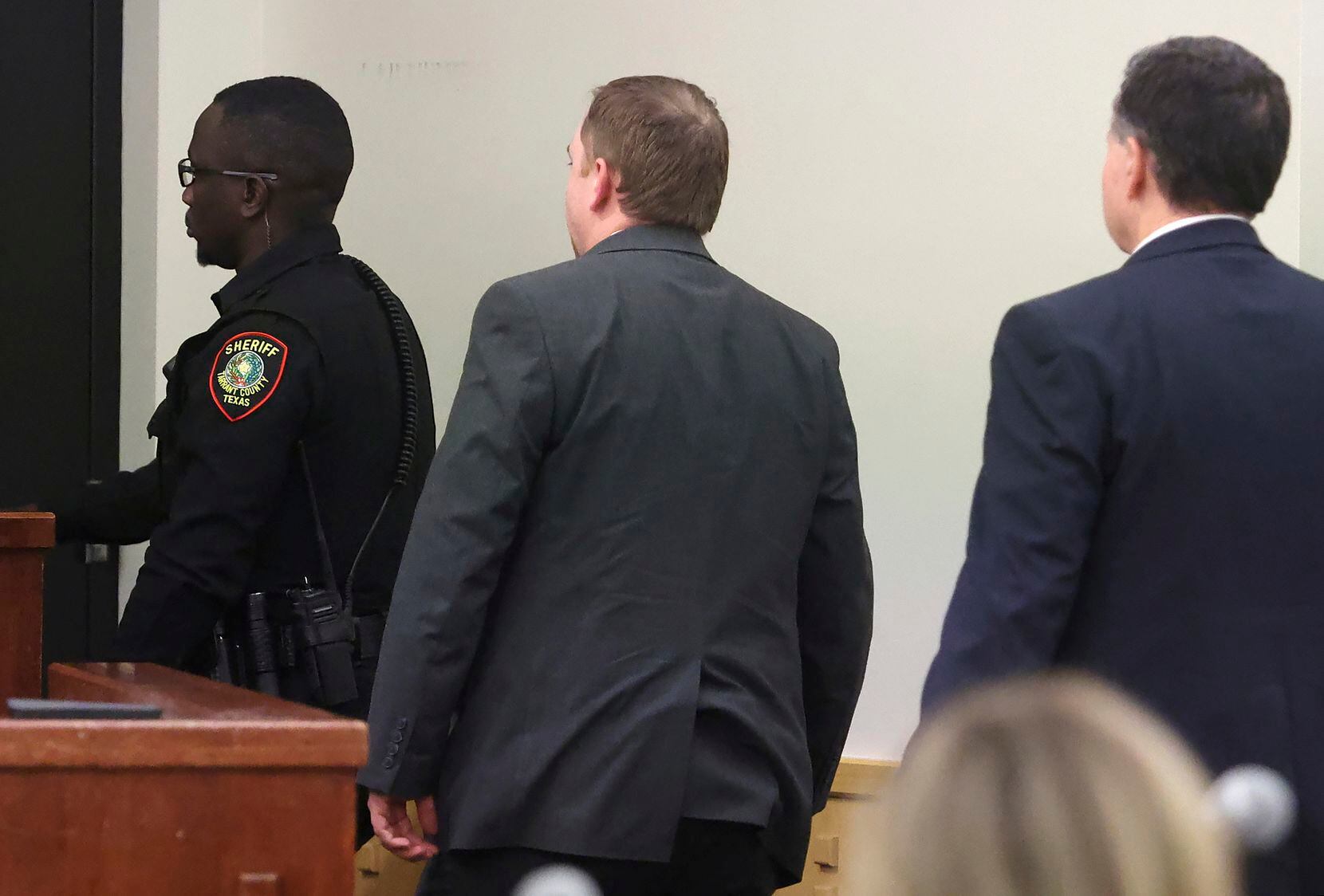 Aaron Dean, center, is escorted out of the courtroom after sentencing on Tuesday, Dec. 20,...