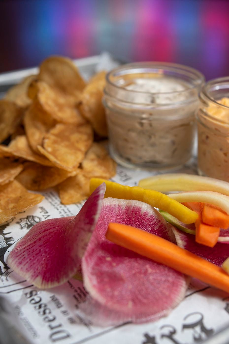 Dynamic Duo, an appetizer, is smoked onion and pimento cheese dip with chips and veggie...