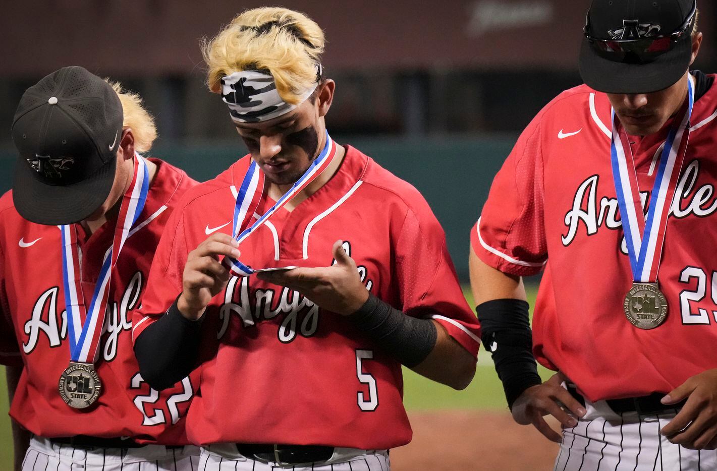 Argyle second baseman Colton Roquemore (5) looks at his second place medal after a 9-0 loss...