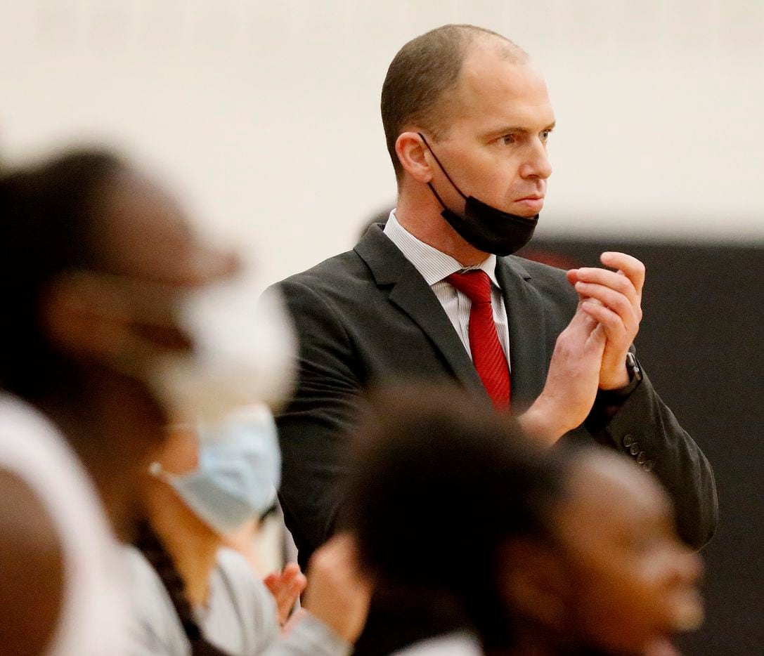 Frisco Liberty High School head coach Ross Reedy applauds his teams effort during the first...