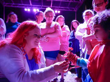 Maitlyn Presley Gandy, left, mother of late Athena Strand gives a flower to Frances Schigg,...